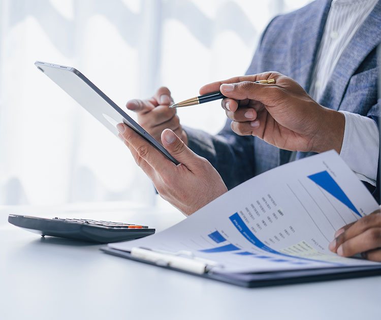 Two sets of hands reviewing financial documents.