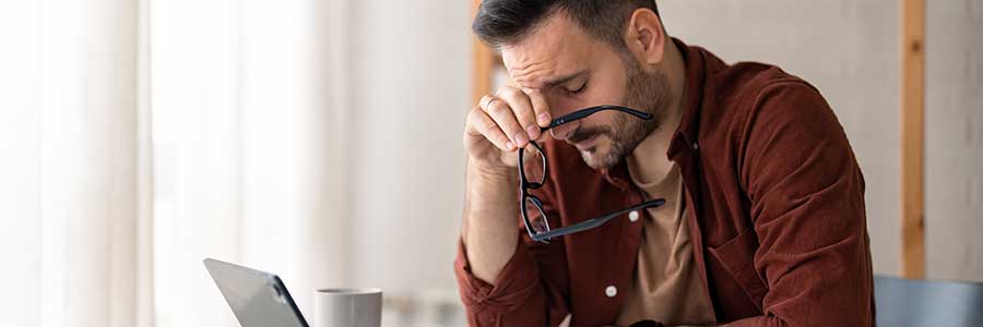 Person looking frustrate looking at computer.