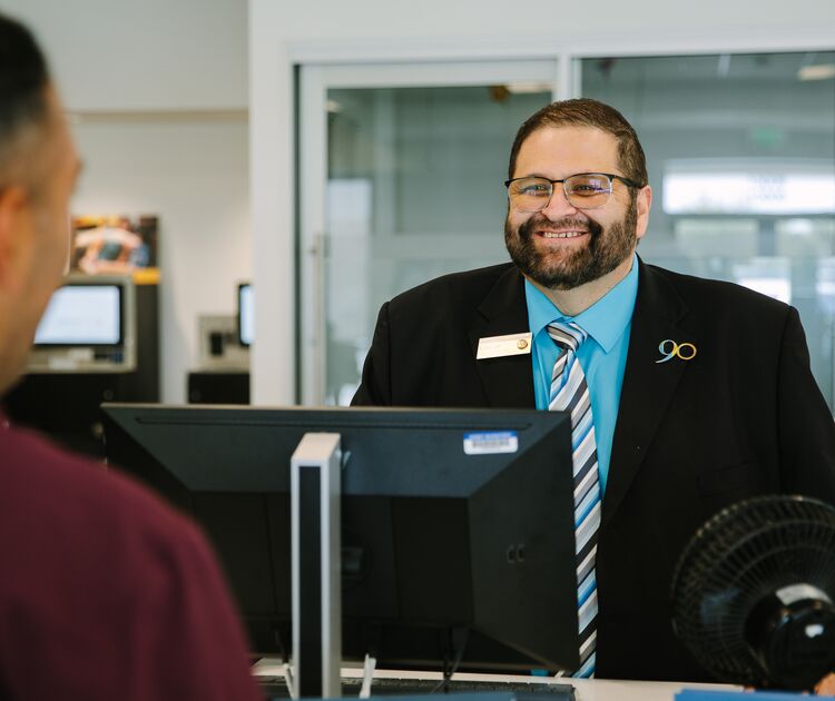 SchoolsFirst FCU Teammember Oscar S. prepares to help a Member.