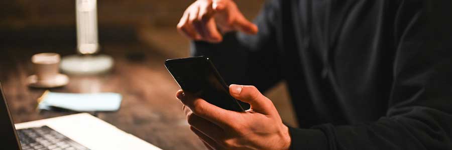 Hands holding a mobile device.