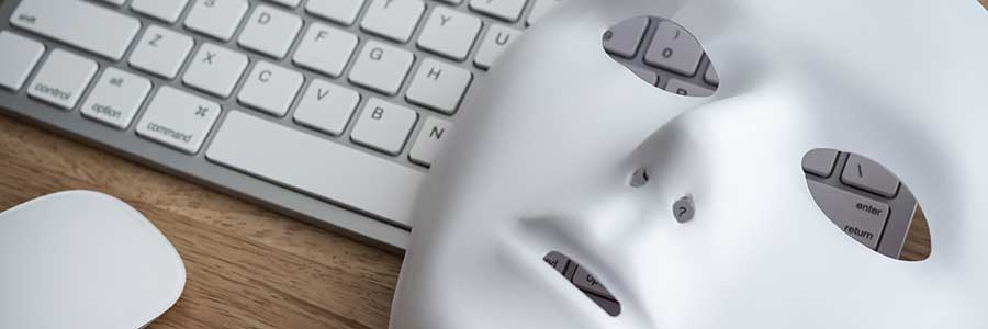 Mask rests atop of keyboard and mouse.