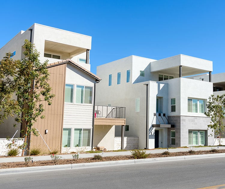 New detached houses along a street in a housing development.